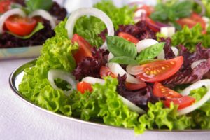 Fresh salad with onion, tomato and basil